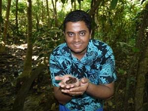 Dr. Narayan holding a Fijian ground frog on Viwa Island.