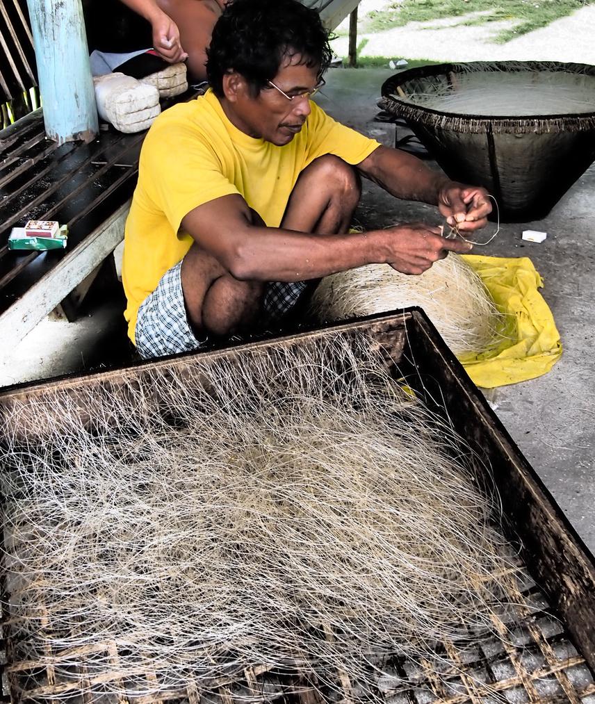Fisherman preparing hook and lines.