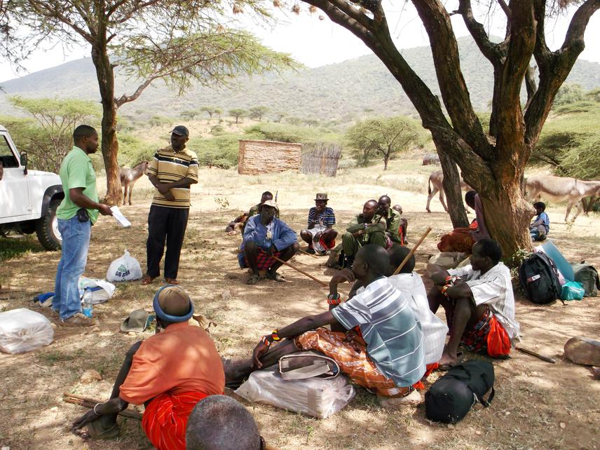 Peter with the help of community wildlife officer (Tom Letiwa) addressig a community meeting at Nkare Narok