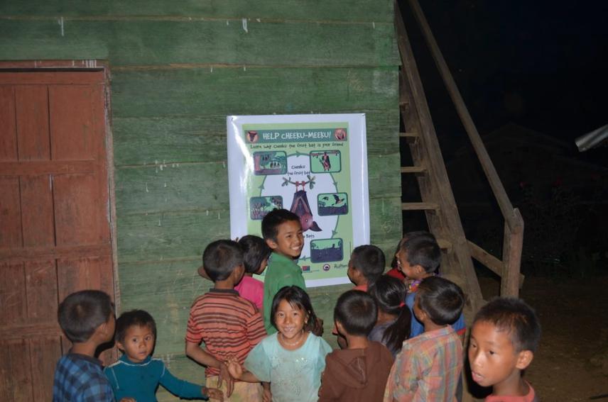Children trying to understand the Poster depicting the role of bats in ecosystem.