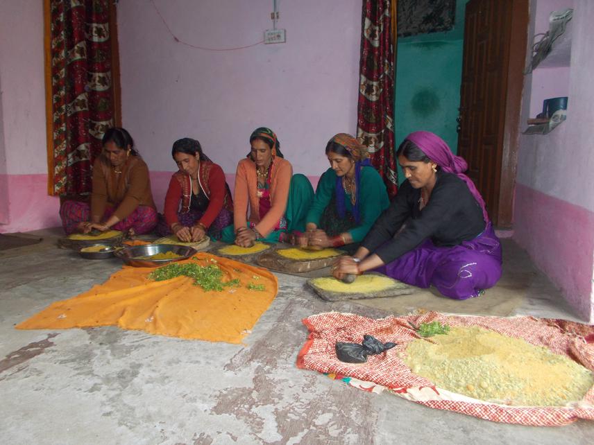 SHG members preparing green salt (a mix of table salt and locally available herbs and spices) to be sold as a Value-added product.