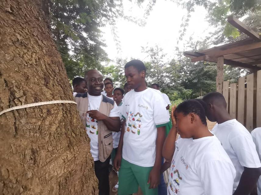Project facilitator demonstrating to citizen scientists how to measure tree diameter.