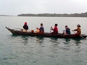 A traditional dugout canoe setting out on a fishing trip.